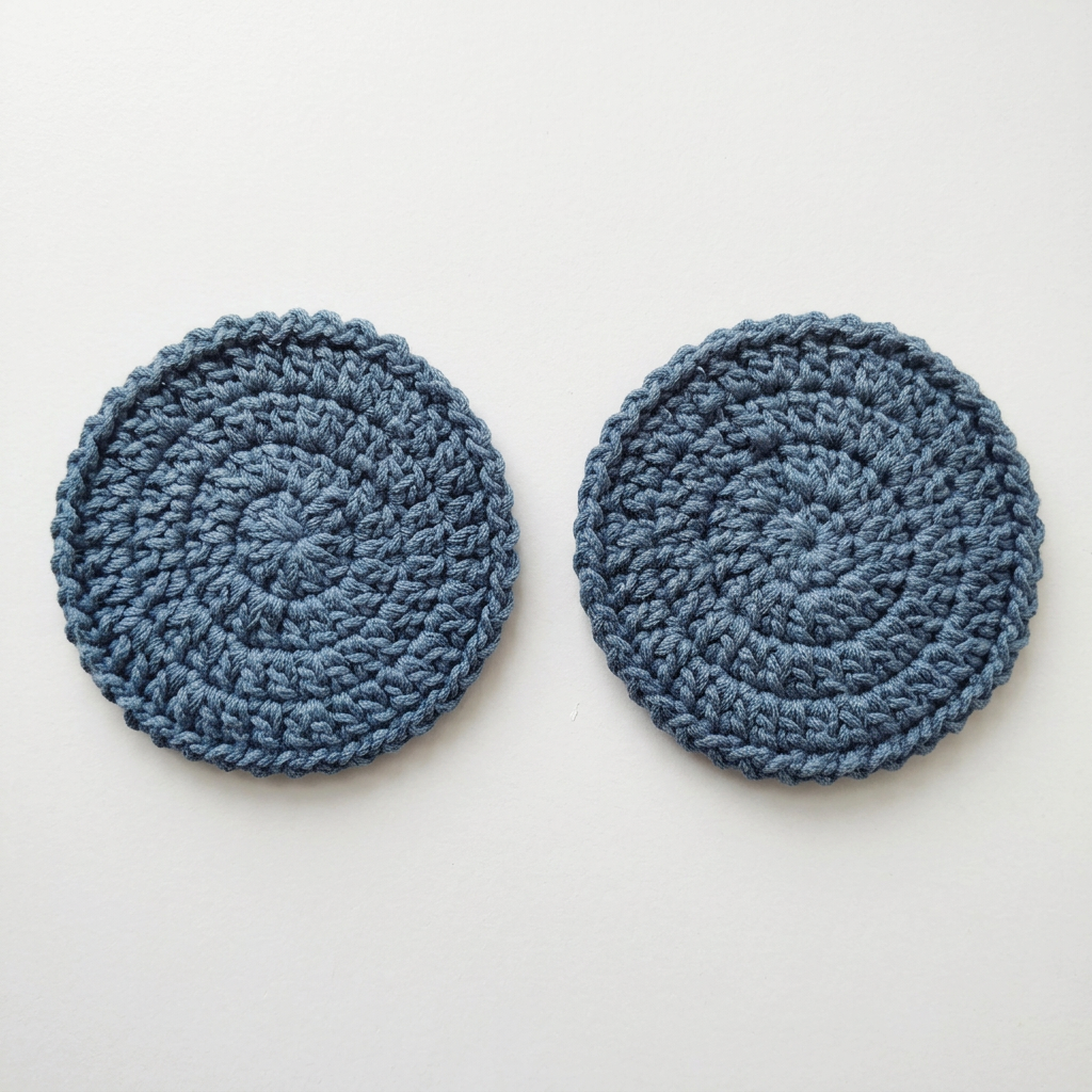 Blue round crochet coasters flat lay on a white table